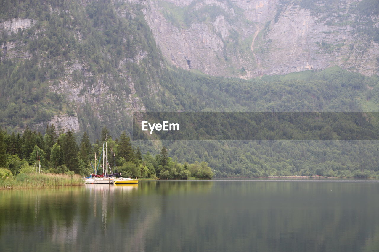 scenic view of lake by mountain