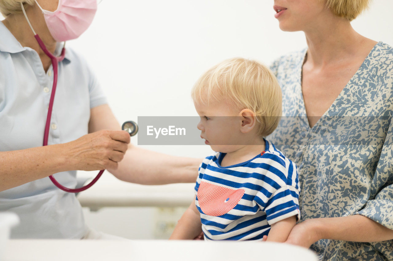 female doctor examining patient in clinic