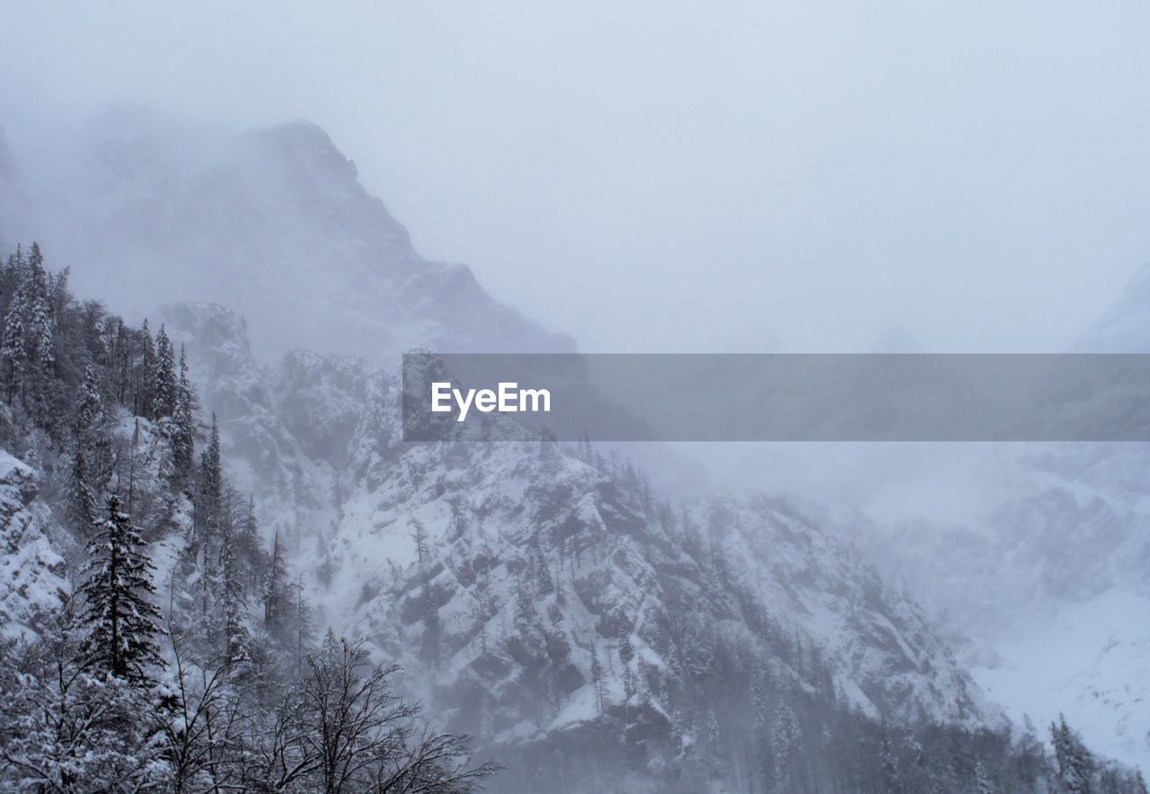 Scenic view of snow covered mountains during winter