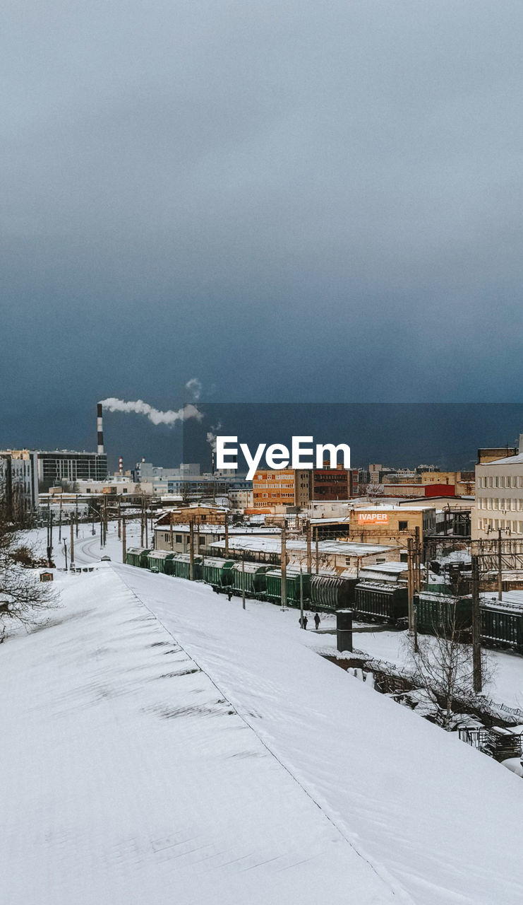 snow, winter, cold temperature, architecture, building exterior, built structure, city, sky, environment, nature, building, landscape, water, no people, travel destinations, cloud, travel, land, storm, outdoors, cityscape, beauty in nature, overcast, transportation, day, business finance and industry, scenics - nature, sea, house, tourism, residential district, street, industry, horizon