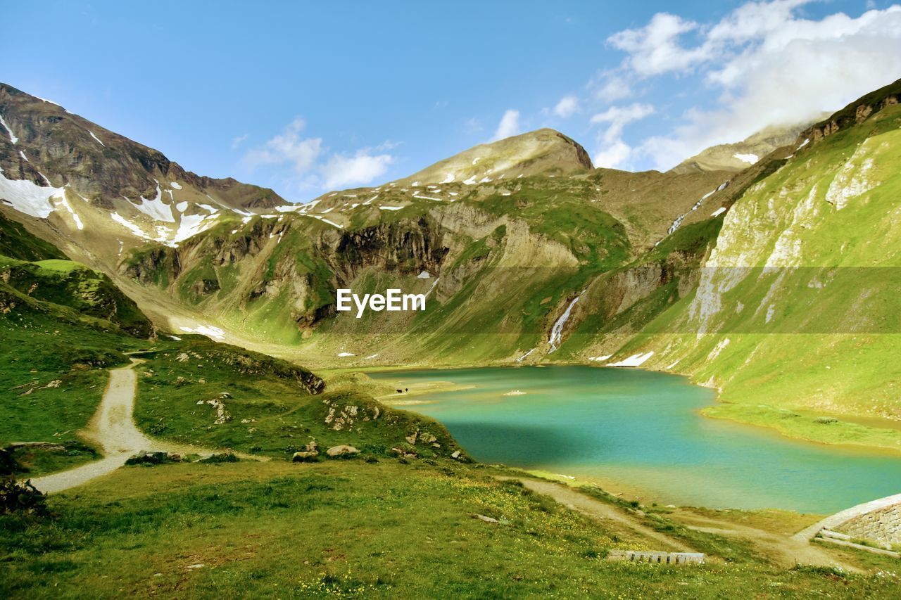 Scenic view of lake and mountains against sky