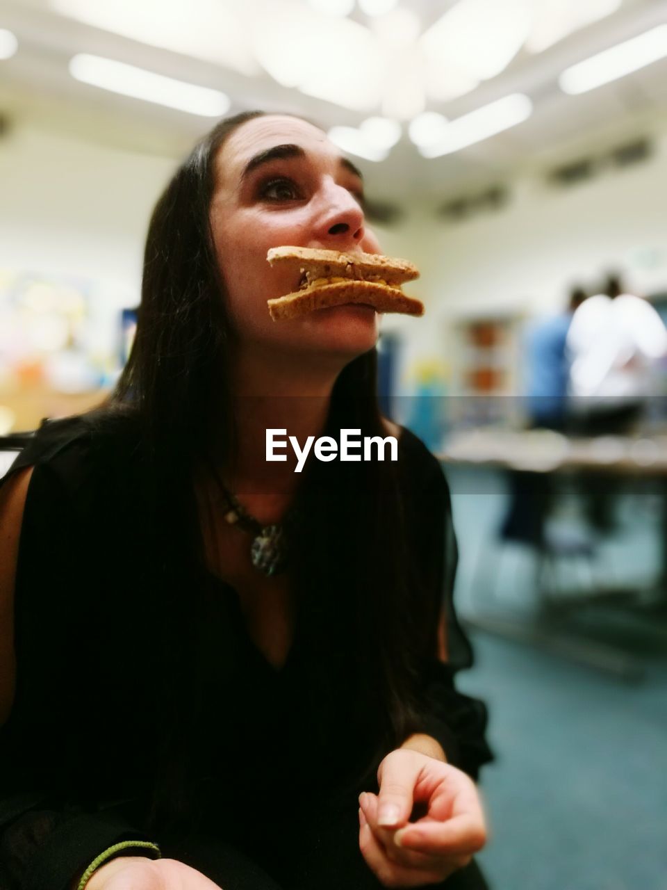 Young woman eating bread