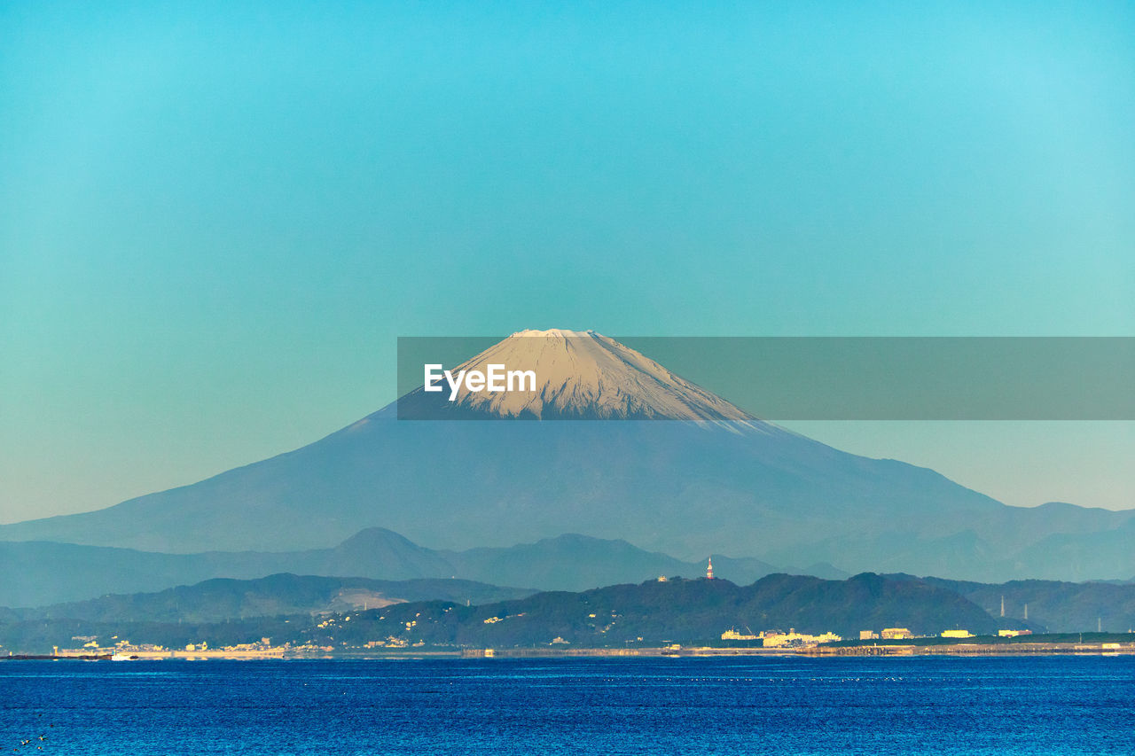 mountain, horizon, volcano, sky, water, sea, scenics - nature, travel destinations, beauty in nature, nature, land, no people, stratovolcano, blue, ocean, travel, landscape, tranquil scene, tranquility, outdoors, day, culture, clear sky, mountain peak, environment, mountain range, dusk, copy space, tourism, volcanic landscape, non-urban scene