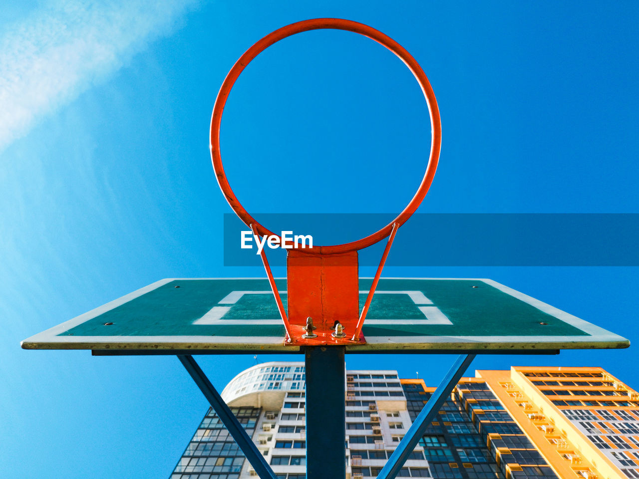 Low angle view of basketball hoop against blue sky