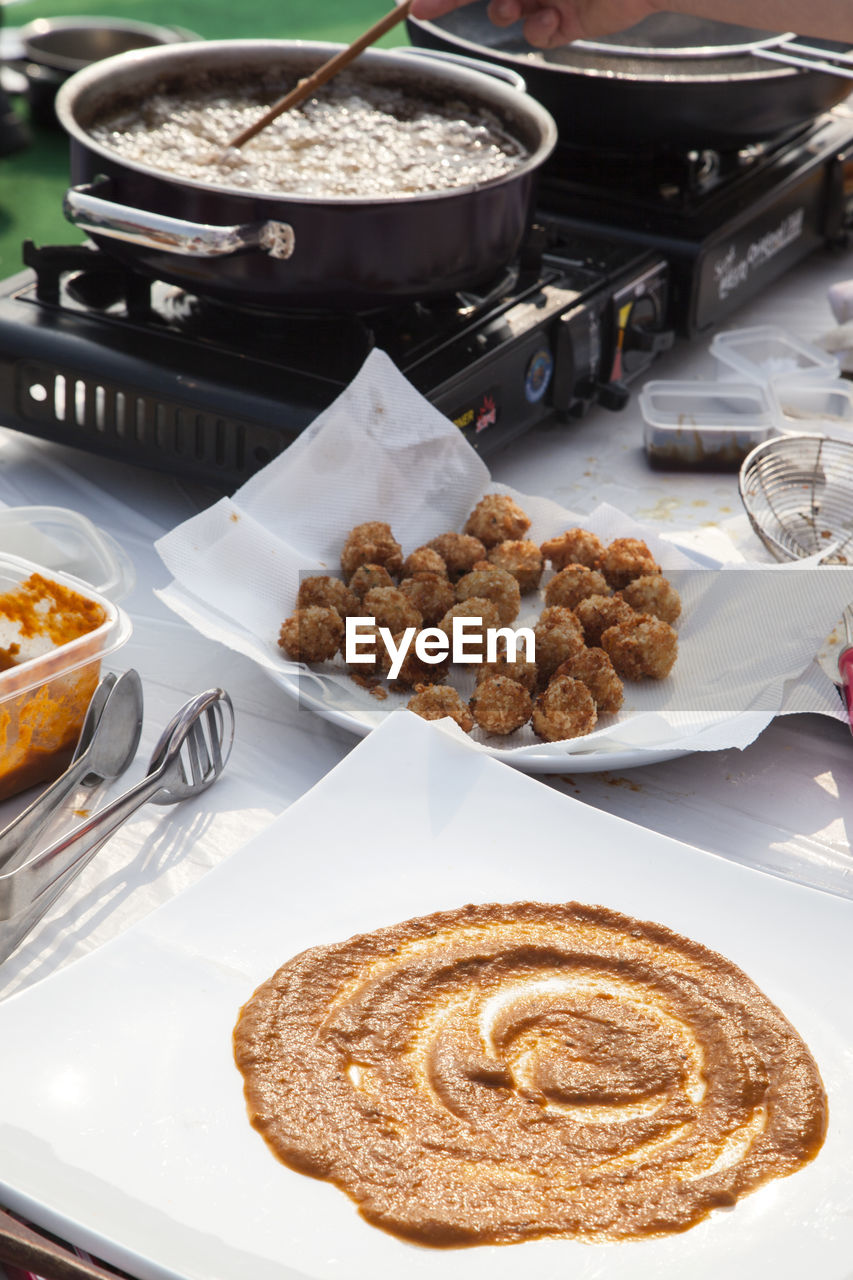 High angle view of food ingredients by stove on table