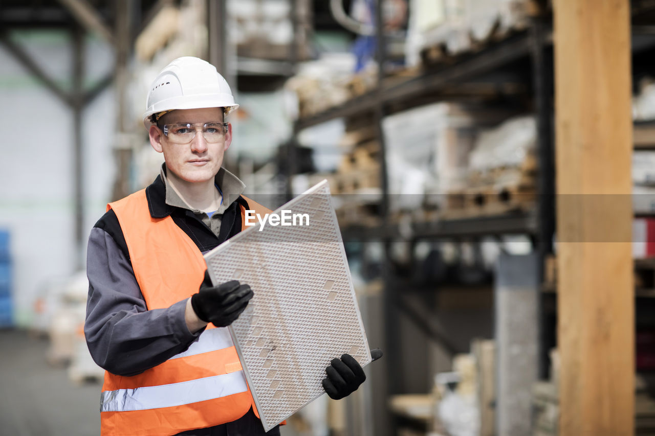 Technician male working in a store watching to product