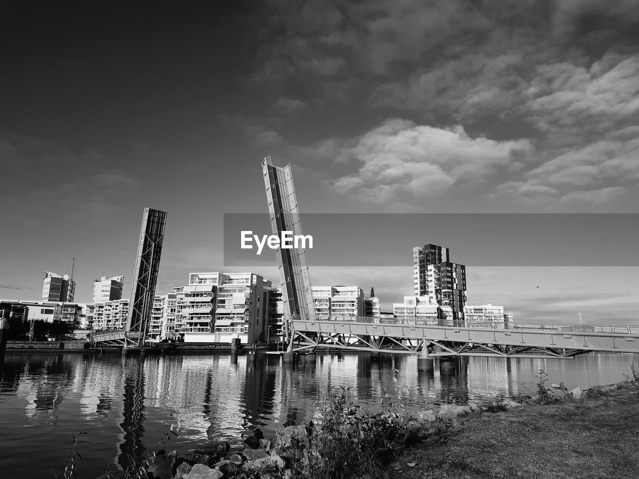 Low angle view of skyscrapers against cloudy sky