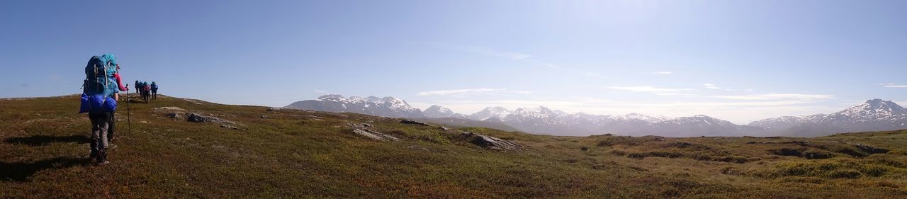 WOMAN STANDING ON MOUNTAIN LANDSCAPE