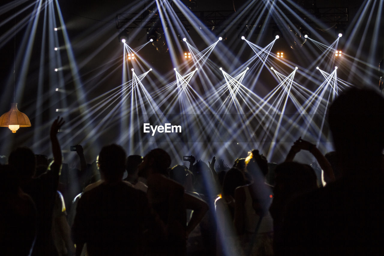 Large group of people enjoying music concert