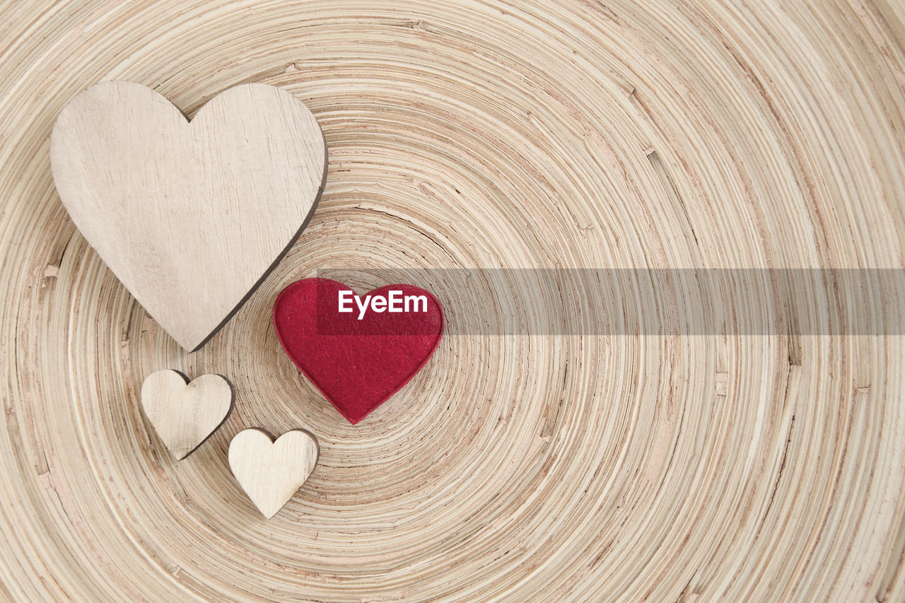 DIRECTLY ABOVE SHOT OF HEART SHAPE MADE ON RED WOODEN WOOD