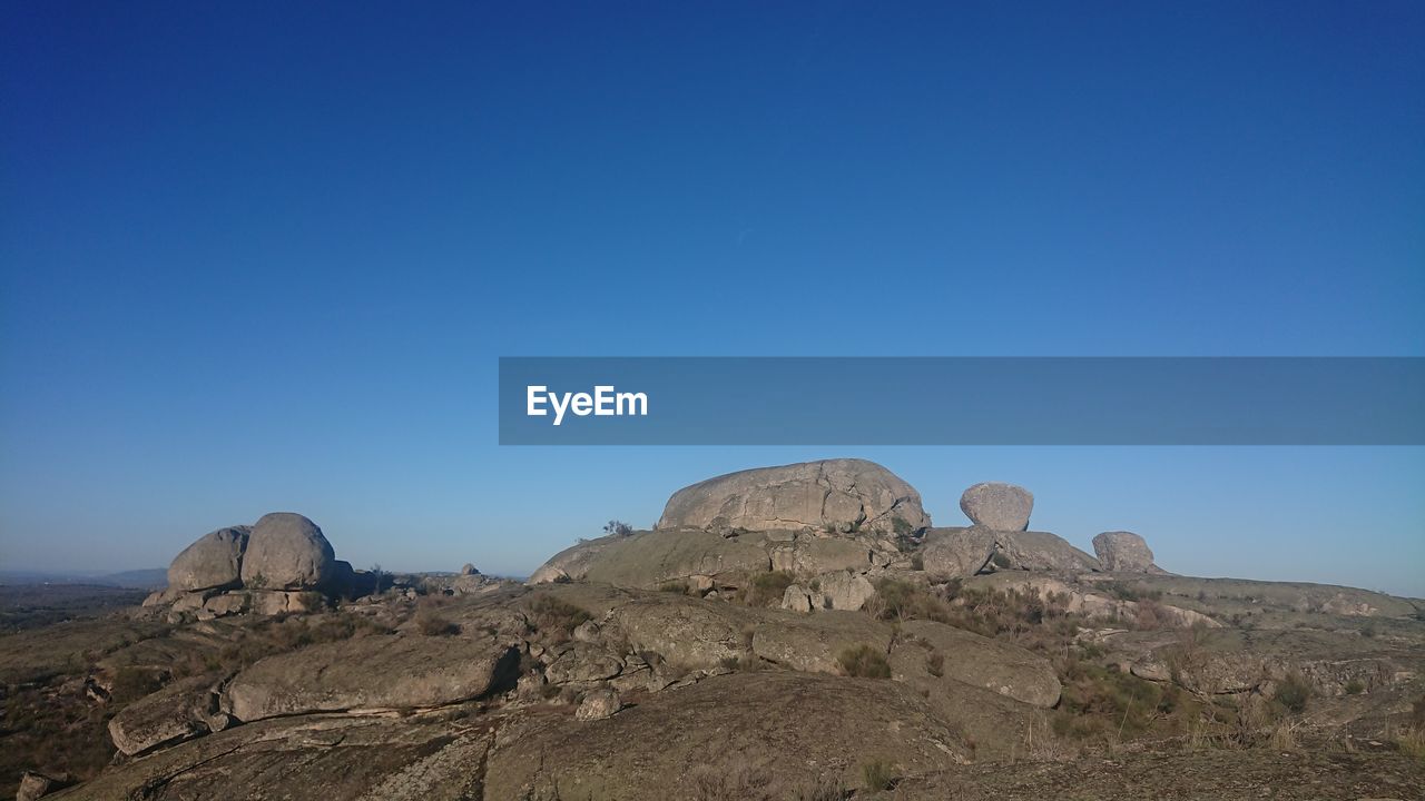 sky, mountain, landscape, scenics - nature, environment, rock, nature, blue, natural environment, travel destinations, desert, travel, clear sky, no people, plateau, land, beauty in nature, rock formation, wilderness, valley, outdoors, geology, non-urban scene, tourism, tranquility, horizon, semi-arid, tranquil scene, sunny, day