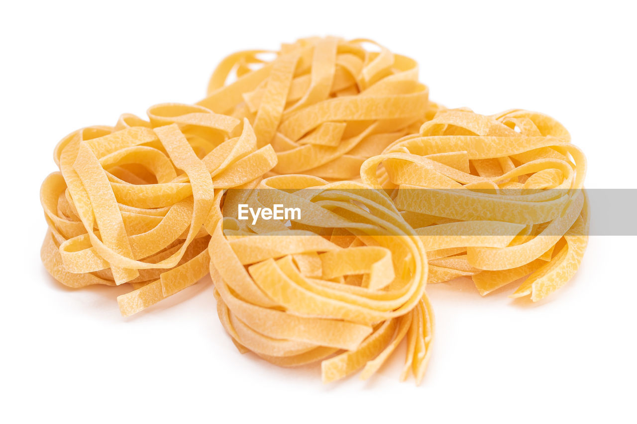 pasta, italian food, food, food and drink, cut out, yellow, freshness, white background, junk food, cuisine, produce, indoors, raw food, no people, spaghetti, studio shot, petal, group