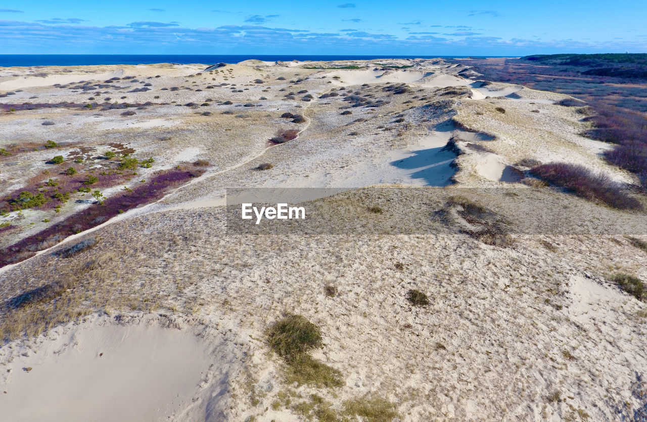 land, water, sea, nature, shore, scenics - nature, coast, natural environment, beach, environment, sky, sand, landscape, beauty in nature, day, tranquility, no people, tranquil scene, travel destinations, geology, blue, travel, outdoors, non-urban scene, ocean, rock, sunlight, desert, tourism