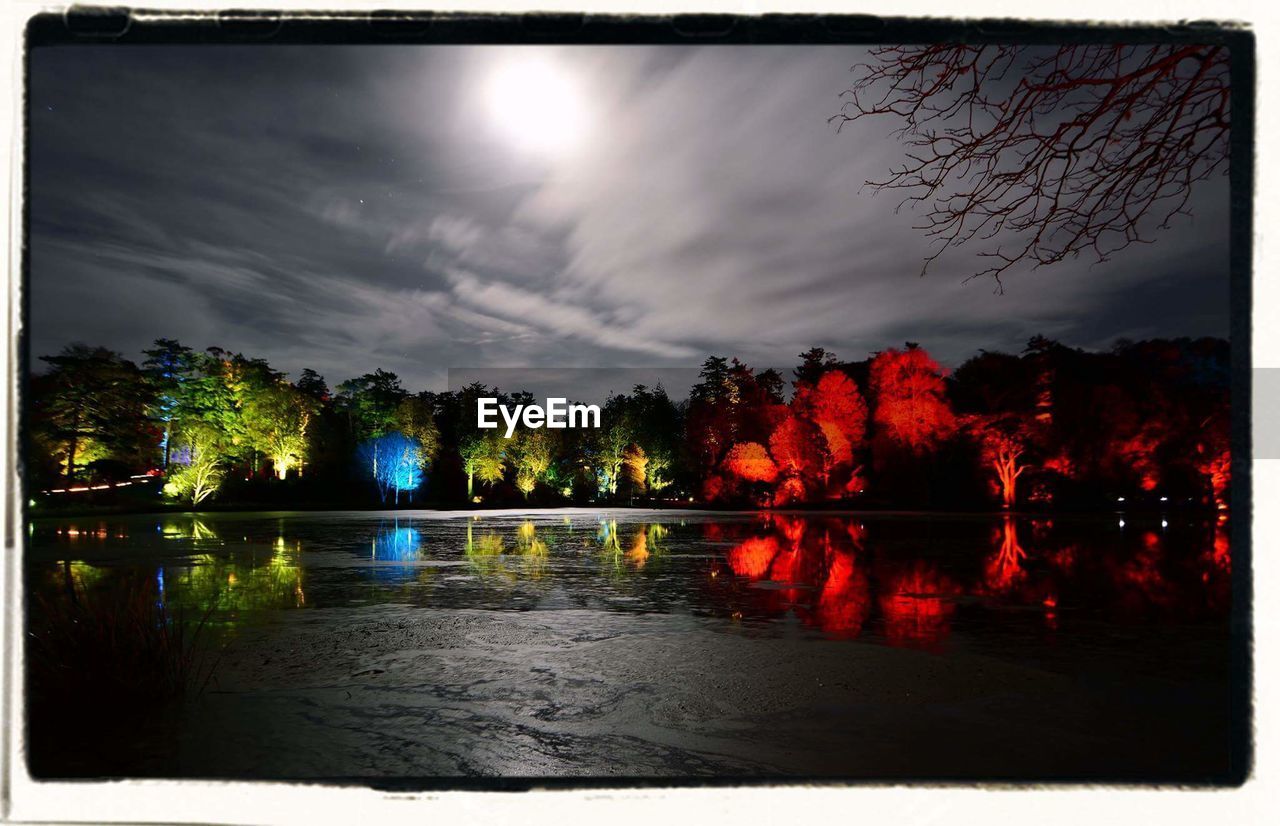 SCENIC VIEW OF CALM LAKE AT DUSK