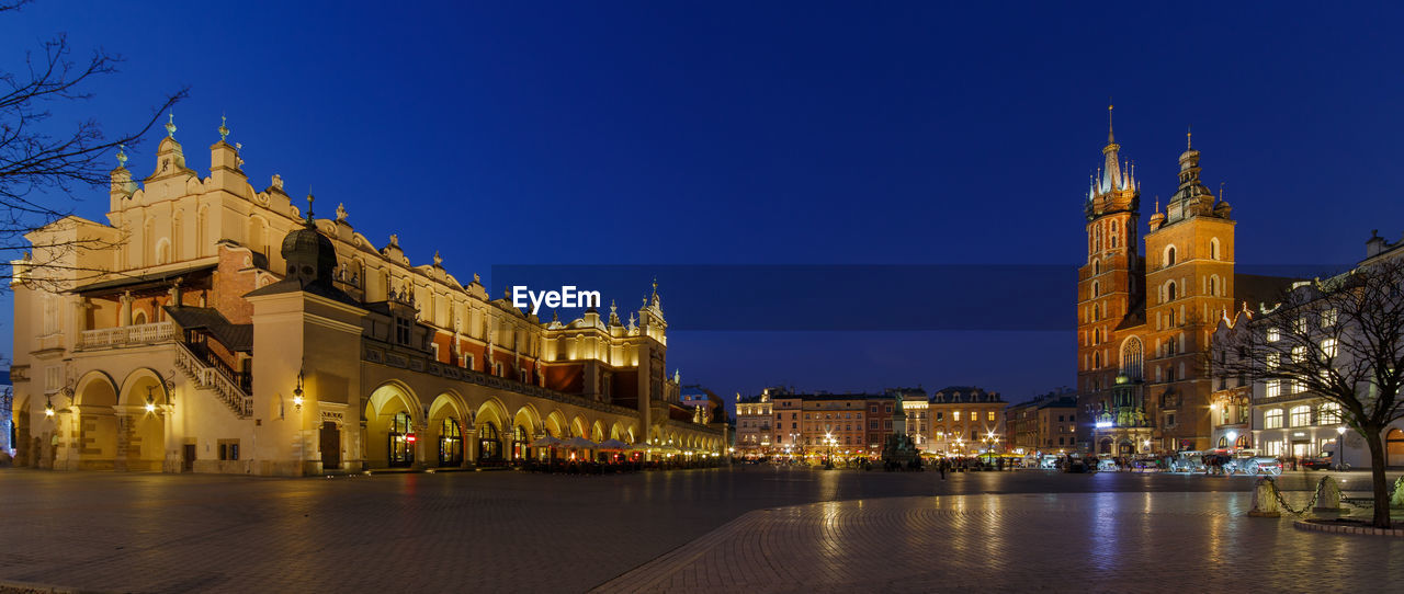 Illuminated cathedral against blue sky at night