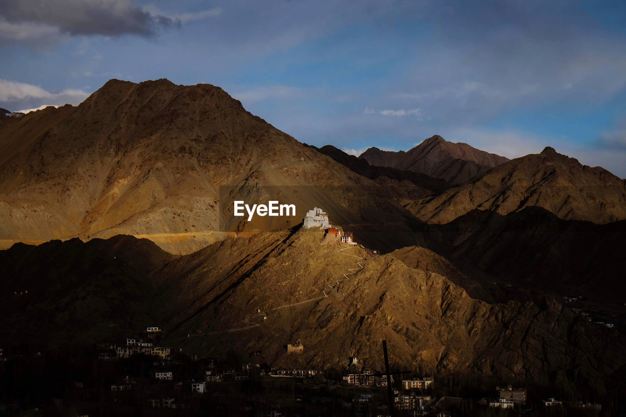 Scenic view of mountain and sunset light shining on leh palace 