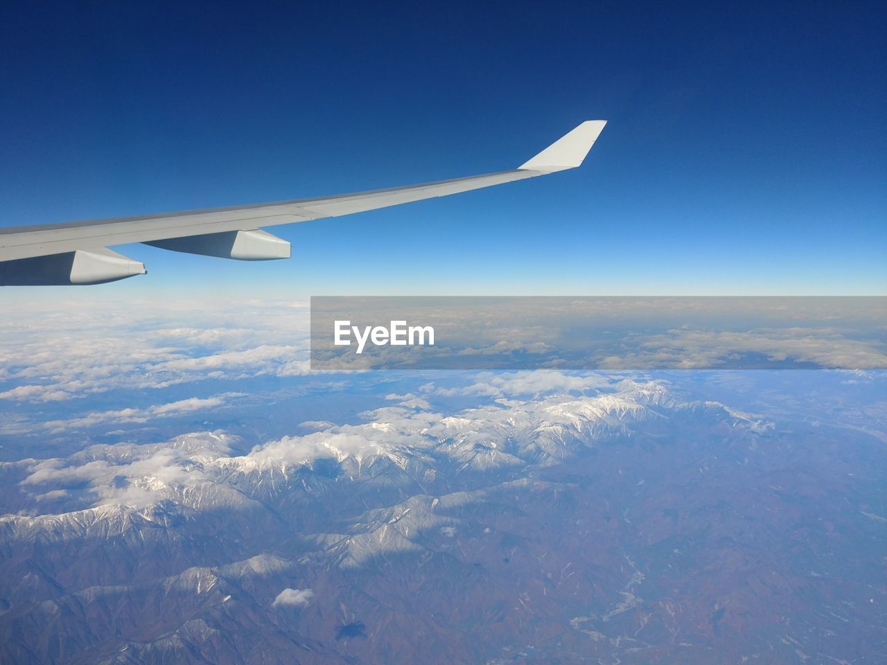 AERIAL VIEW OF AIRPLANE WING OVER LANDSCAPE