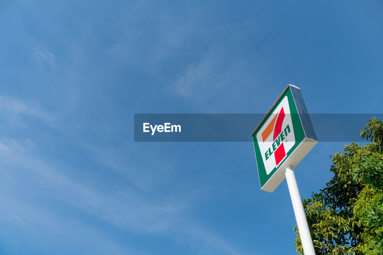 LOW ANGLE VIEW OF FLAG SIGN AGAINST SKY