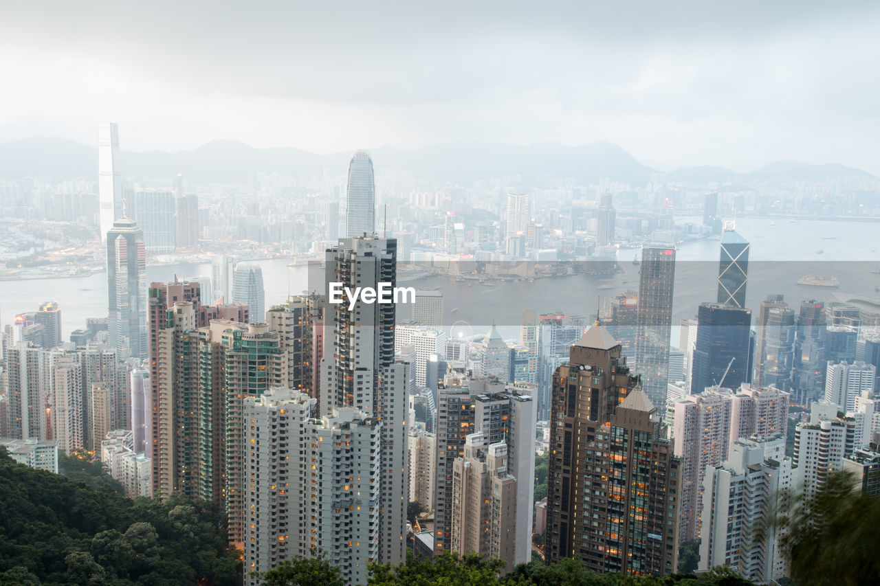 High angle view of modern buildings in city against sky