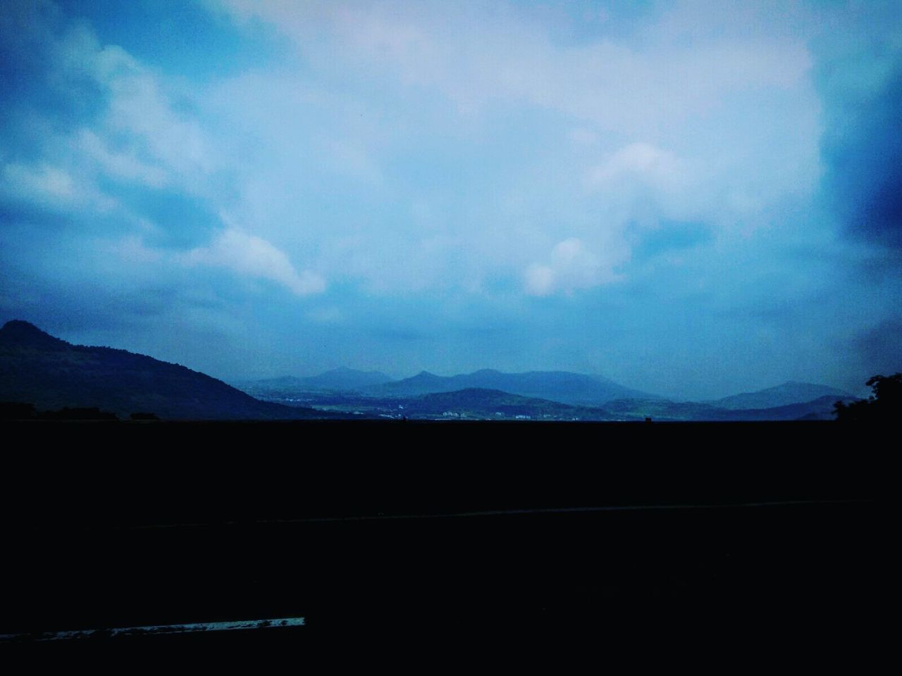 SILHOUETTE MOUNTAINS AGAINST SKY AT NIGHT