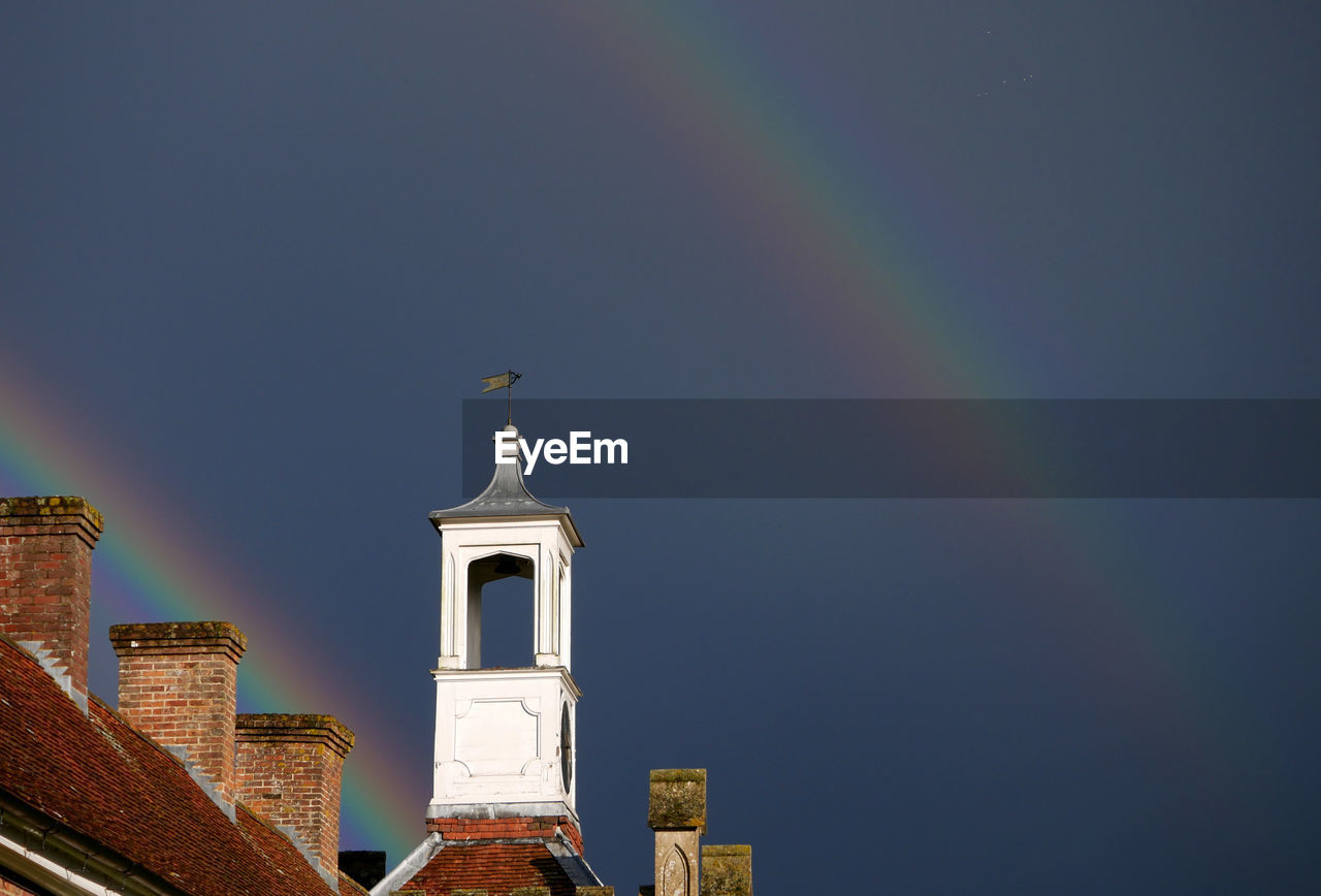 LOW ANGLE VIEW OF BELL TOWER AGAINST BLUE SKY