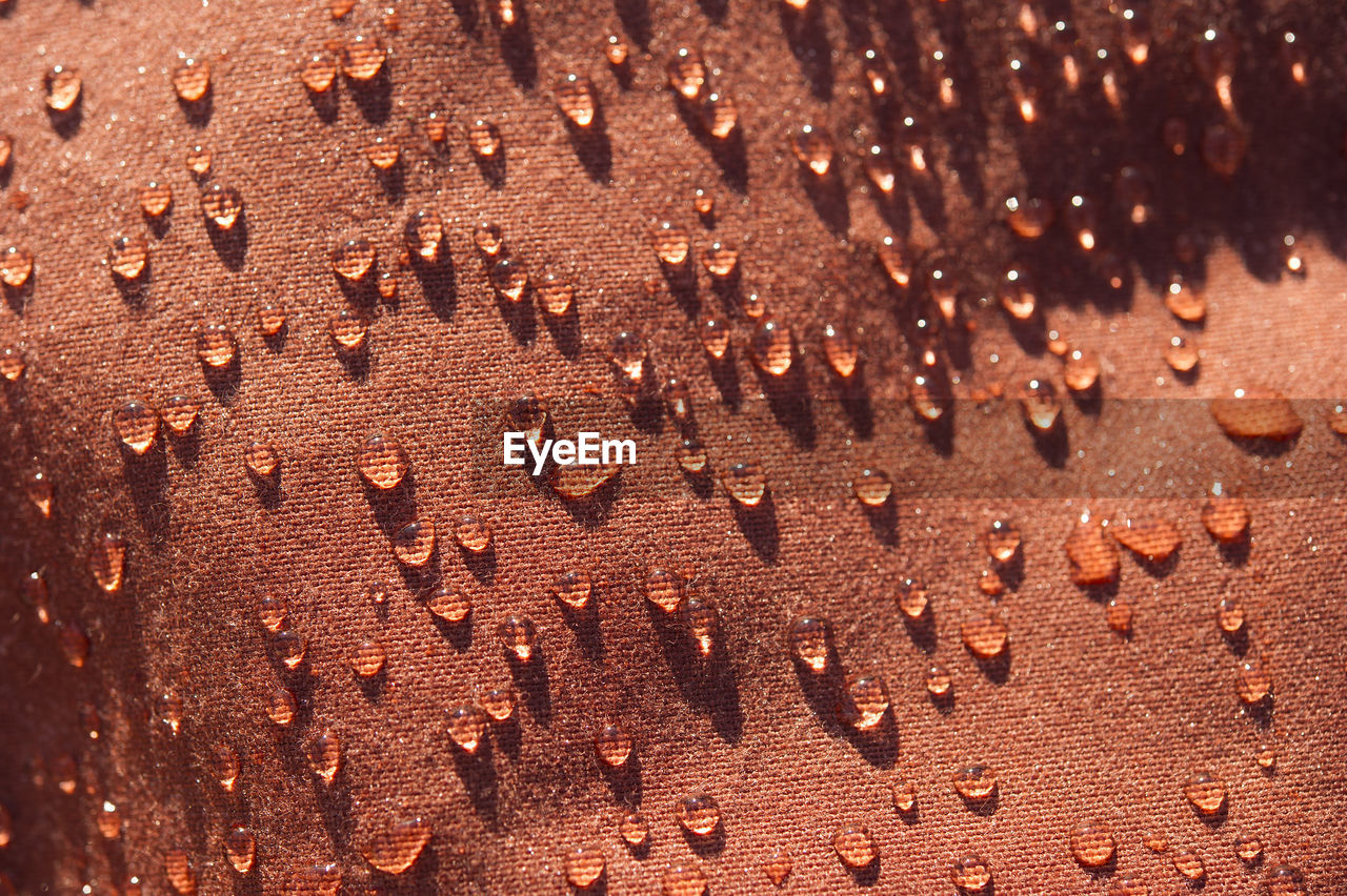 Full frame shot of drops on brown fabric