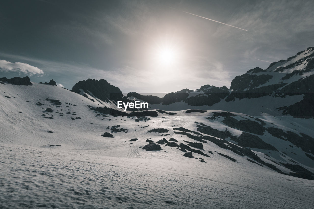 Scenic view of snow covered mountains against sky