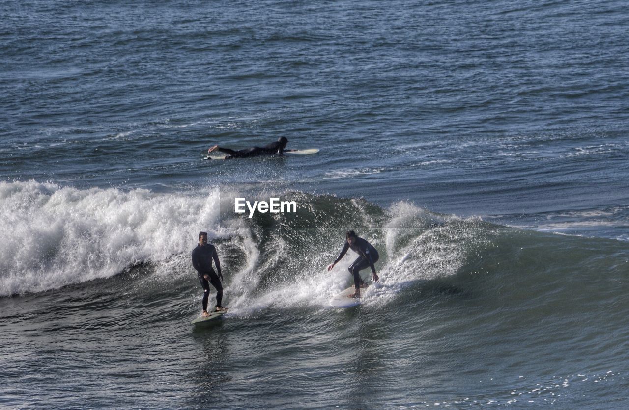 MAN SURFING ON SEA