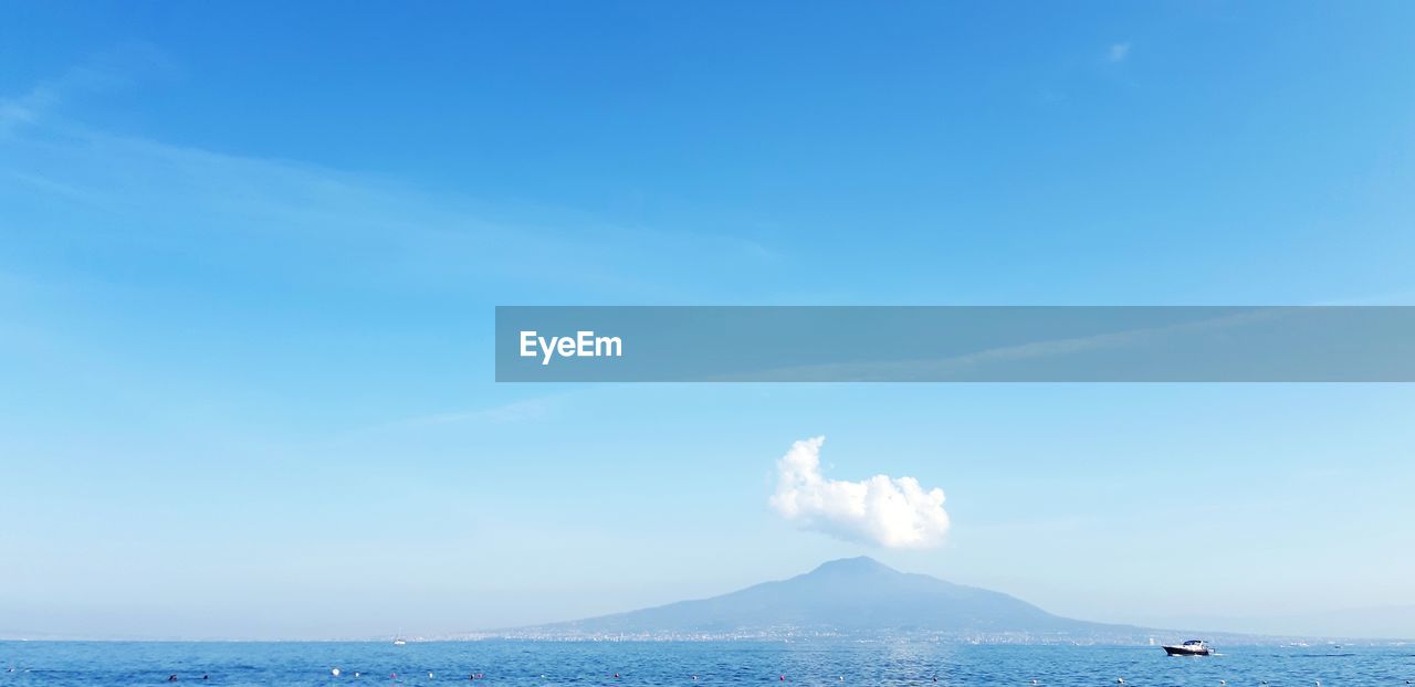 Scenic view of sea against blue sky