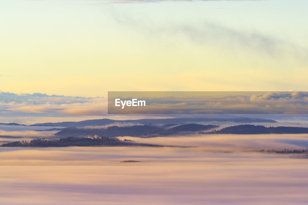 sky, cloud, scenics - nature, beauty in nature, sunset, dawn, tranquility, tranquil scene, horizon, nature, mountain, no people, environment, idyllic, mountain range, landscape, dramatic sky, outdoors, cloudscape, reflection, sunlight, travel, evening, aerial view, plain, orange color, non-urban scene, day