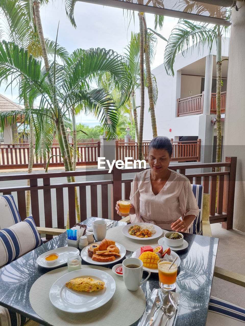 portrait of woman sitting on table in restaurant