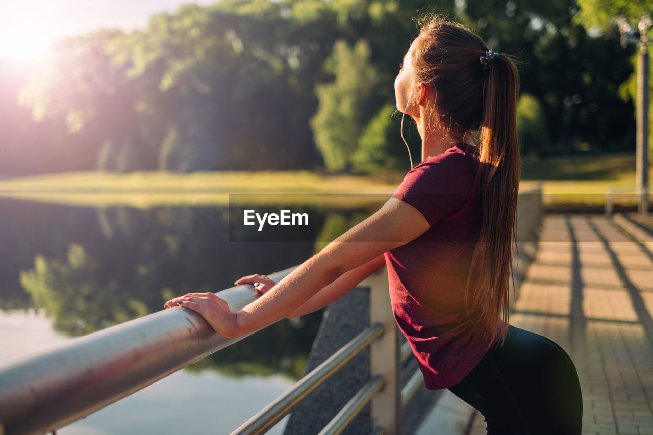 Woman sitting on railing