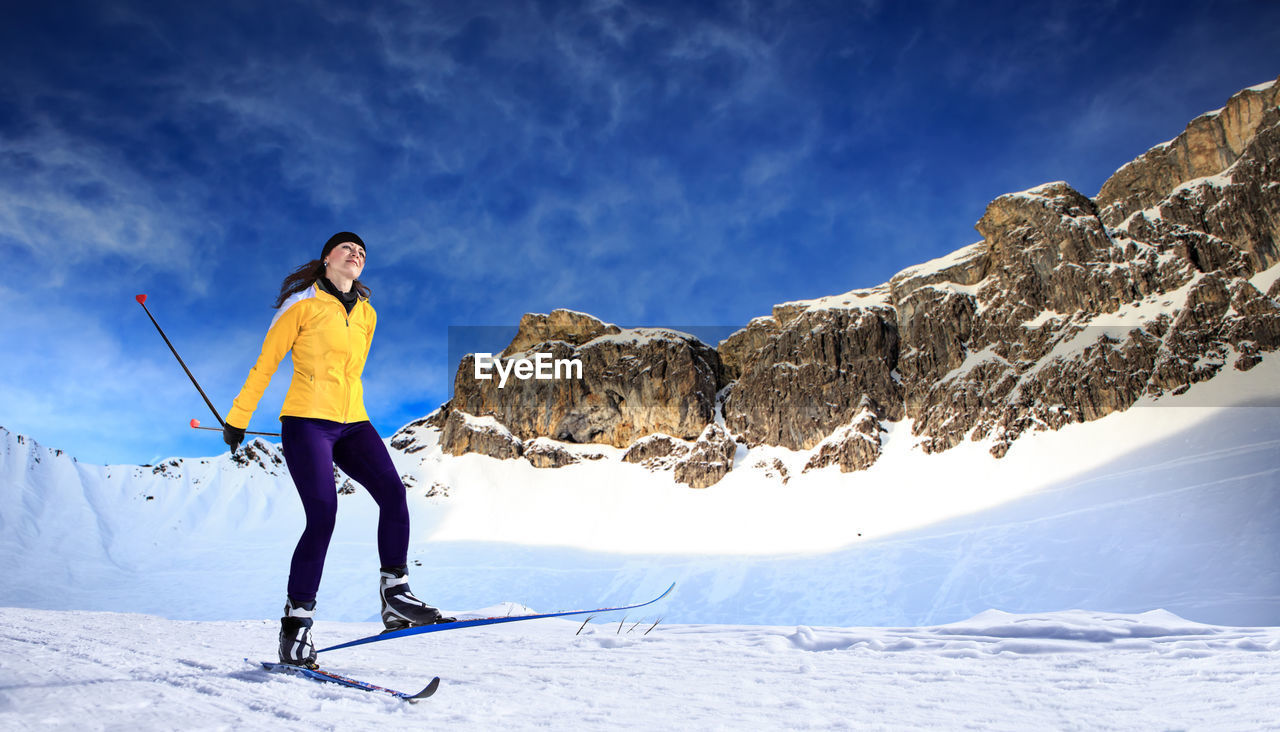 Full length of woman skiing on snow