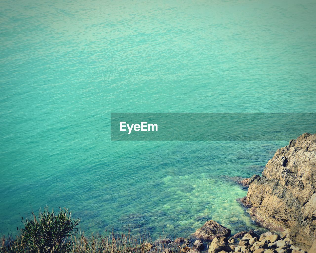 High angle view of rocks by sea