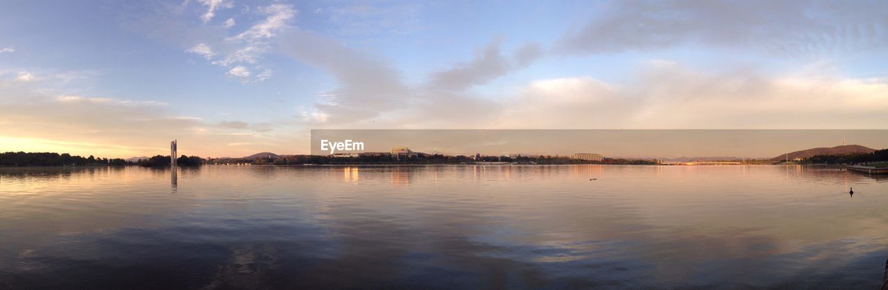 PANORAMIC SHOT OF LAKE AGAINST SKY DURING SUNSET