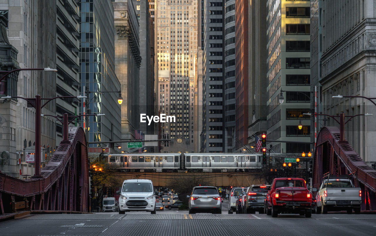 Traffic on city street amidst buildings