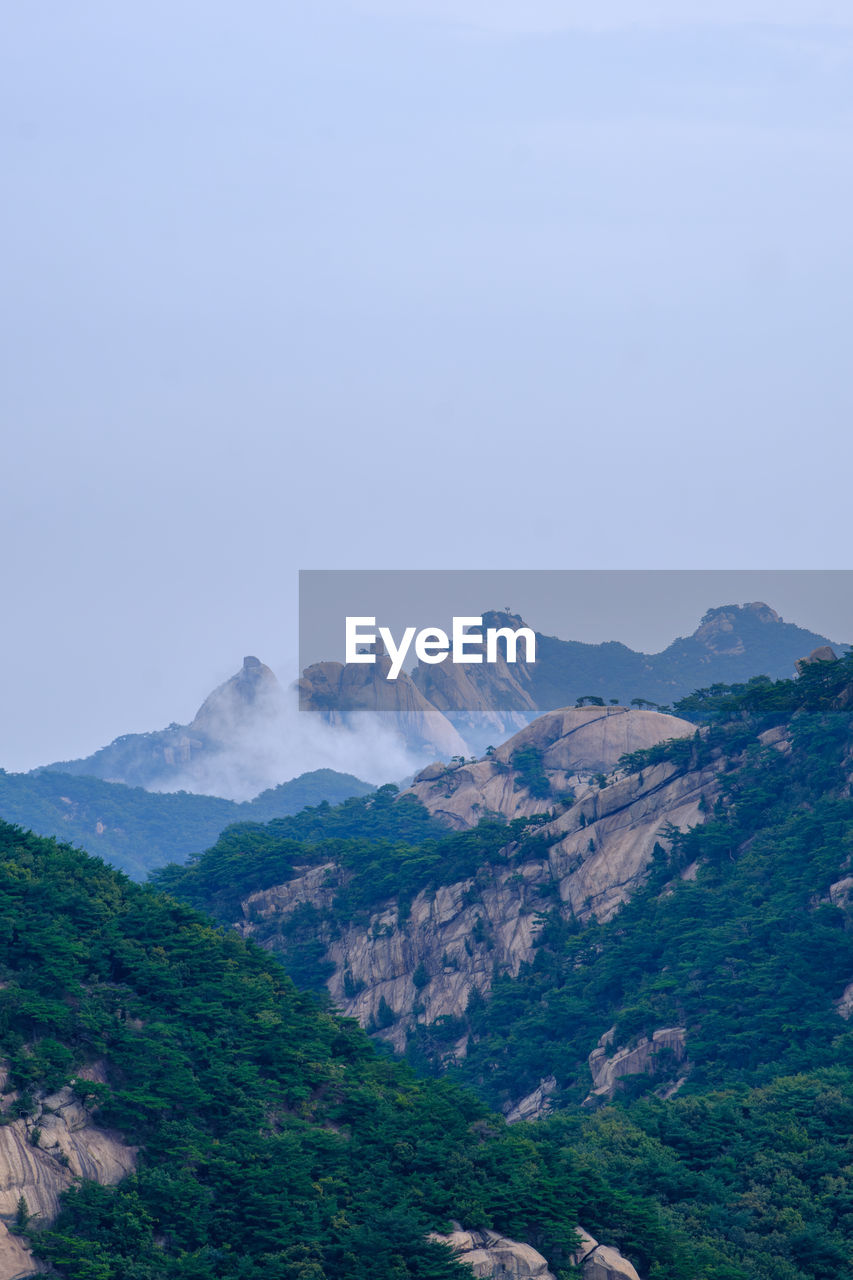 mountain, environment, scenics - nature, landscape, sky, beauty in nature, mountain range, nature, land, travel destinations, travel, plant, no people, tree, tranquility, tranquil scene, non-urban scene, tourism, outdoors, forest, fog, cloud, coniferous tree, pine tree, pinaceae, rock, blue, day, copy space, valley, plateau, idyllic, ridge, water