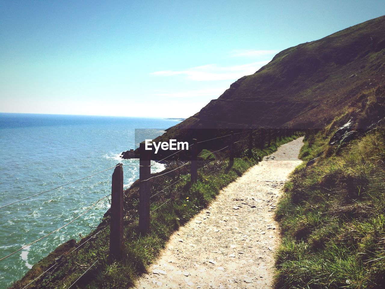 Empty footpath by sea