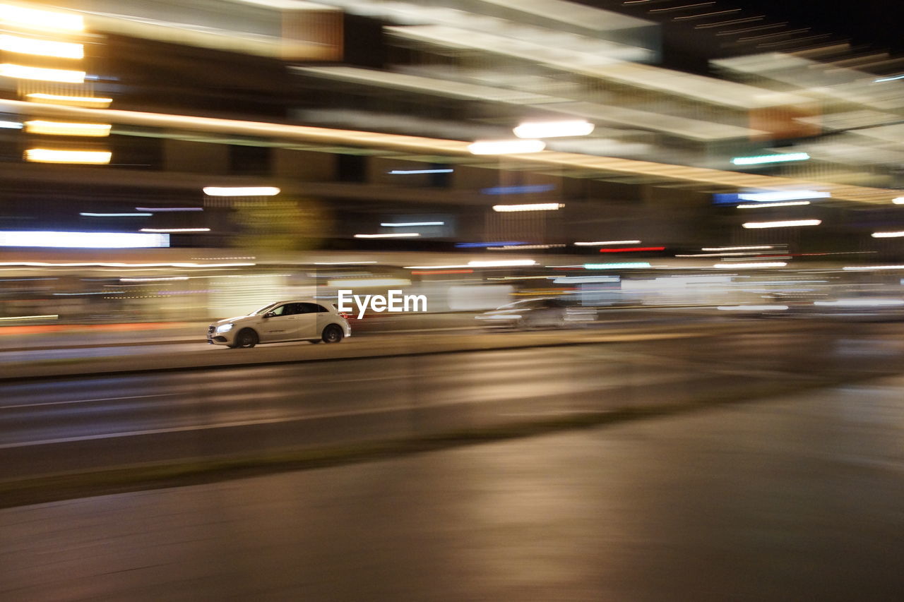 BLURRED MOTION OF CARS ON ROAD IN CITY