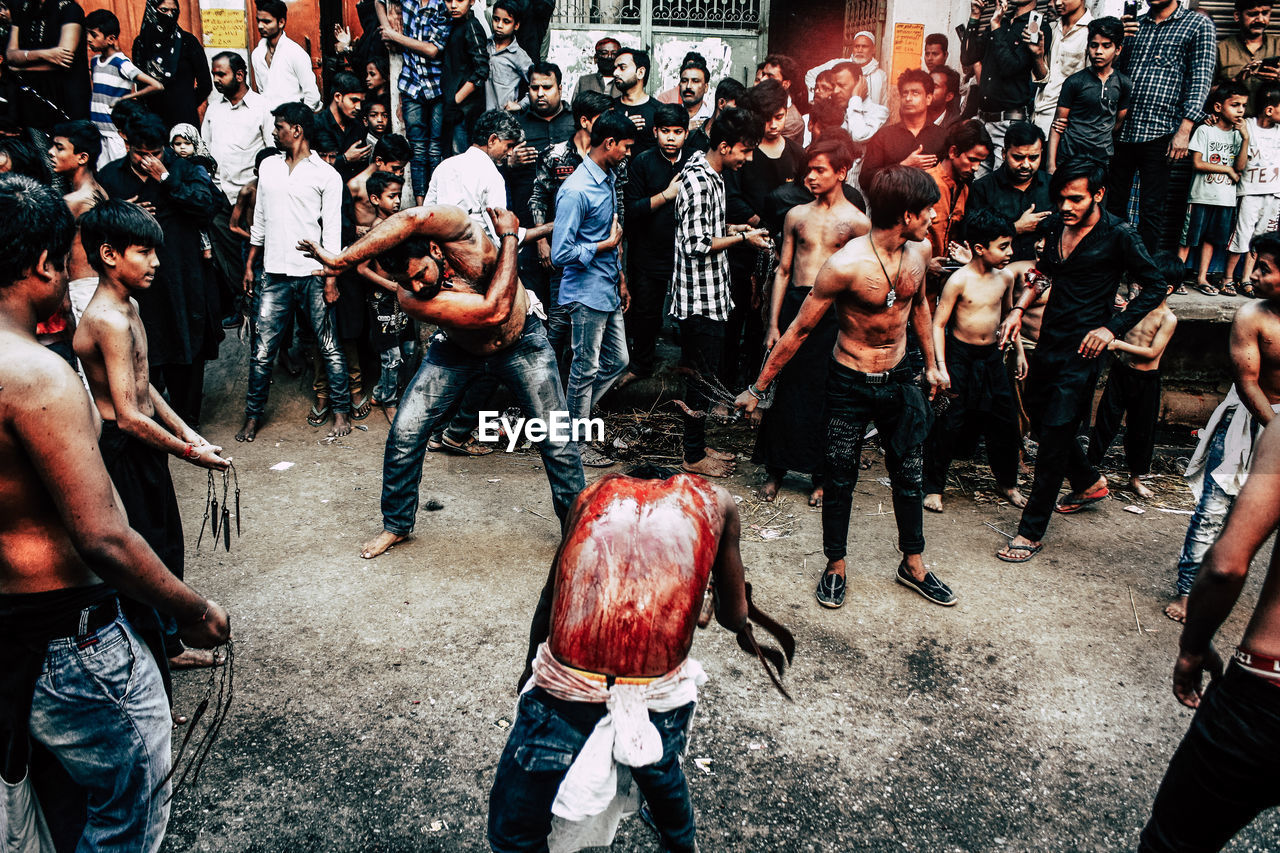 GROUP OF PEOPLE STANDING ON STREET