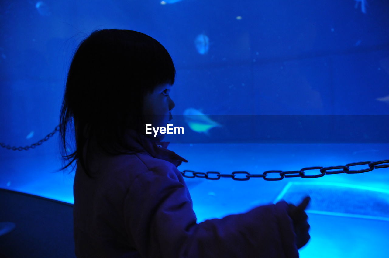 Girl looking at aquarium