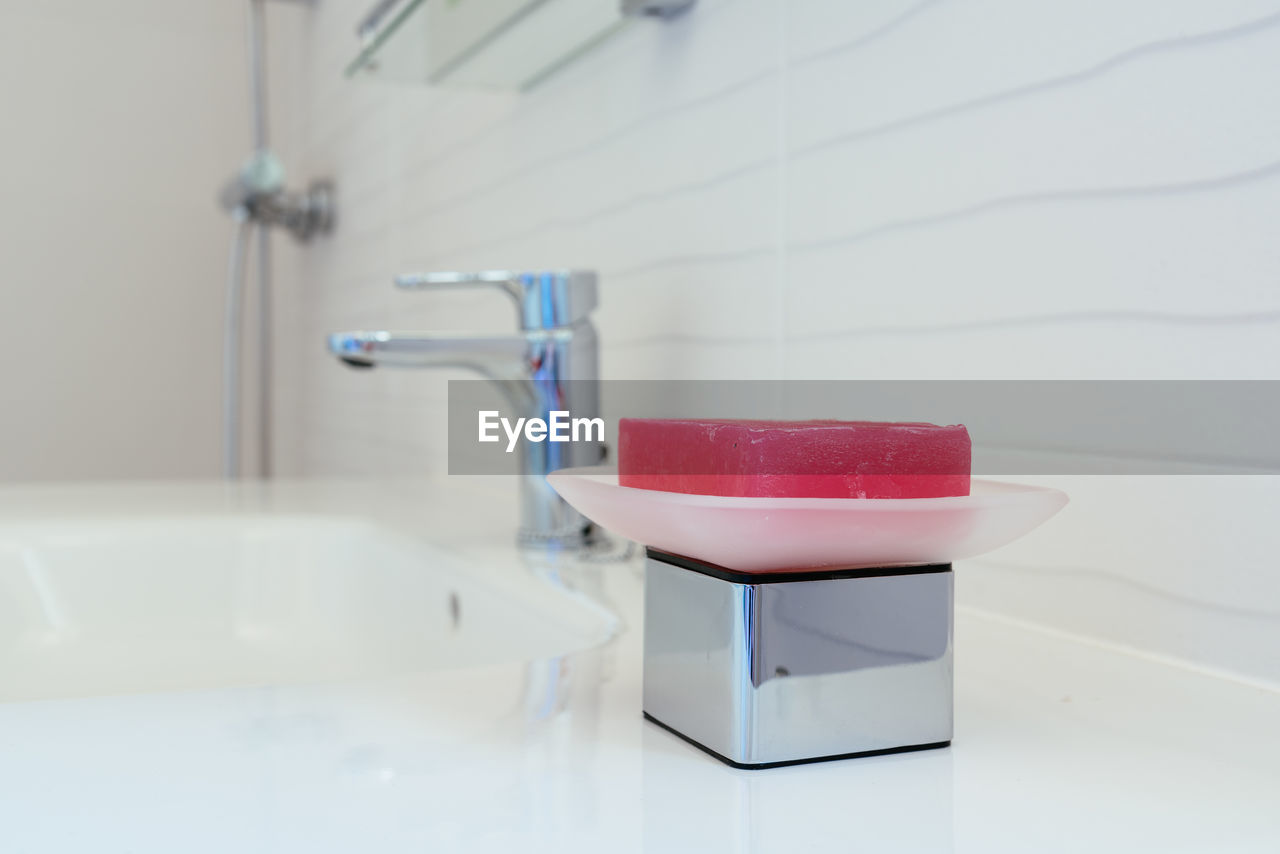 Close-up of soap bar in the sink. concept of cleaning and disinfection during covid-19 pandemic.