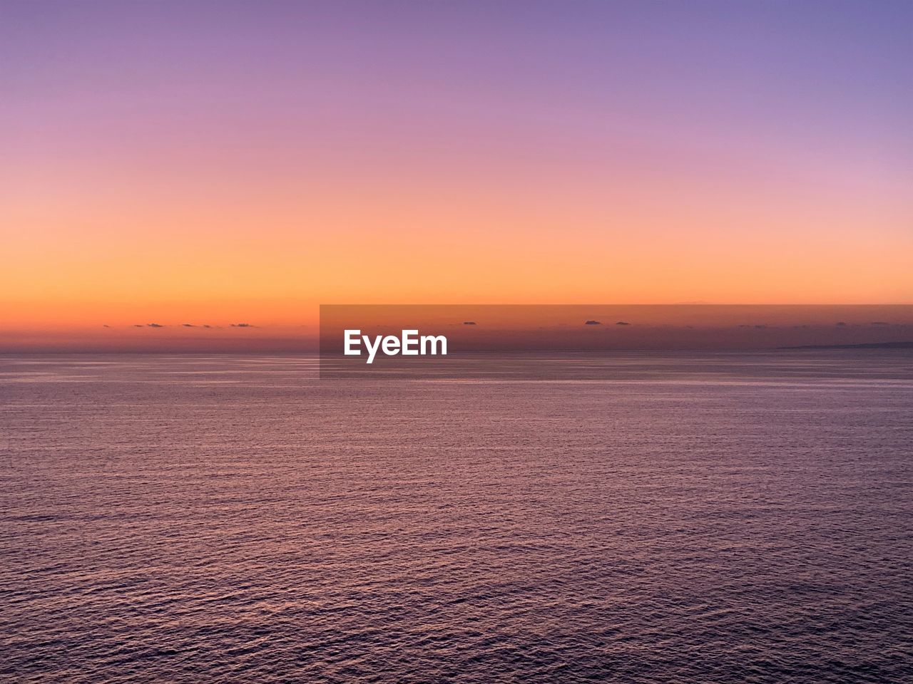 Scenic view of sea against romantic sky at sunset
