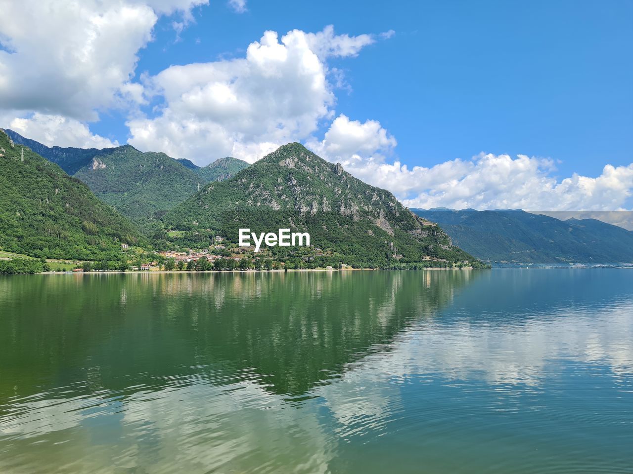 Scenic view of lake and mountains against sky