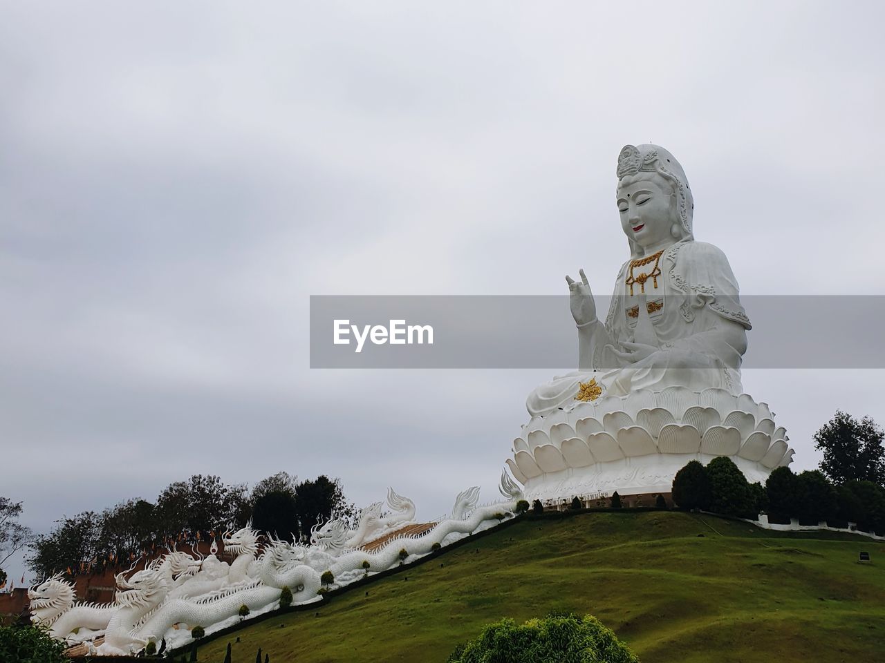 sculpture, sky, statue, cloud, religion, nature, representation, landmark, plant, architecture, no people, belief, human representation, travel destinations, spirituality, monument, travel, environment, tree, outdoors, landscape, overcast, creativity, history, tourism, built structure, craft, day, male likeness, building