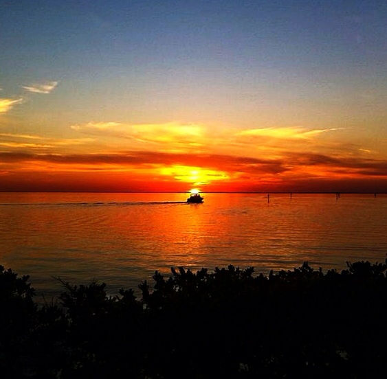 sky, water, sunset, sea, afterglow, beauty in nature, scenics - nature, tranquility, orange color, nature, tranquil scene, cloud, horizon over water, horizon, dawn, idyllic, silhouette, reflection, transportation, no people, nautical vessel, red sky at morning, sun, beach, ocean, mode of transportation, outdoors, evening, sunlight, coast, dramatic sky, land, non-urban scene, shore, travel, ship, travel destinations