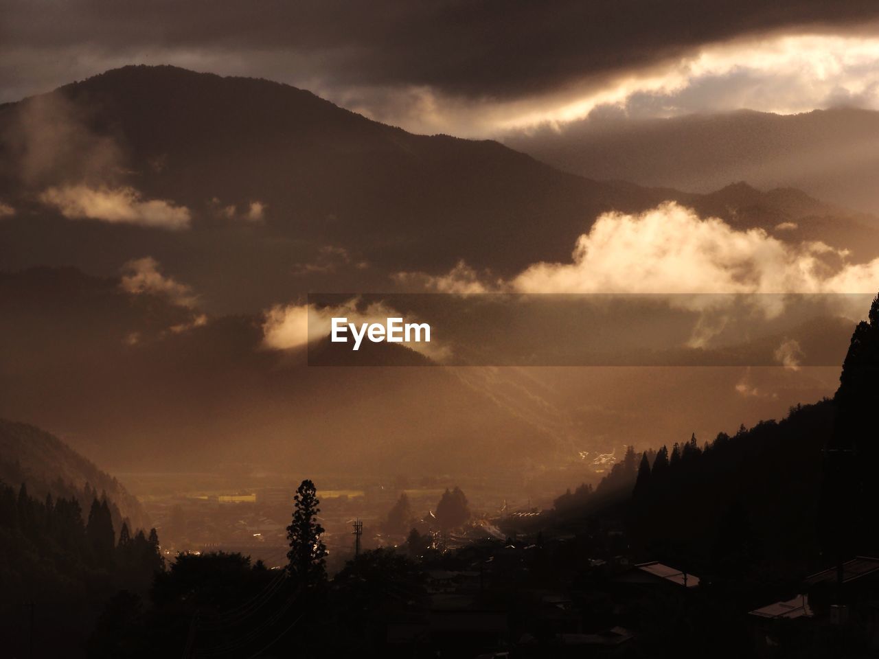 Silhouette of mountain against cloudy sky