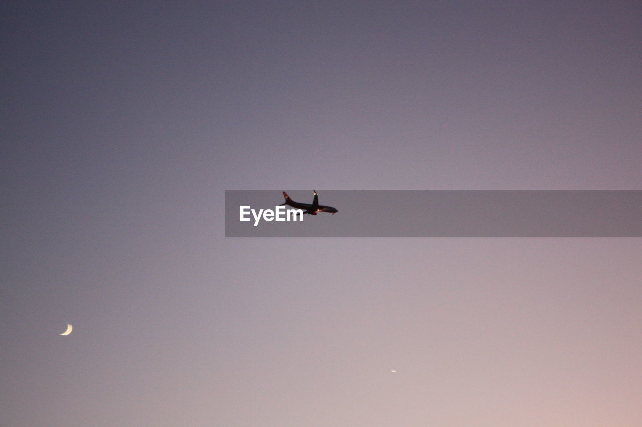 LOW ANGLE VIEW OF AIRPLANE FLYING AGAINST SKY