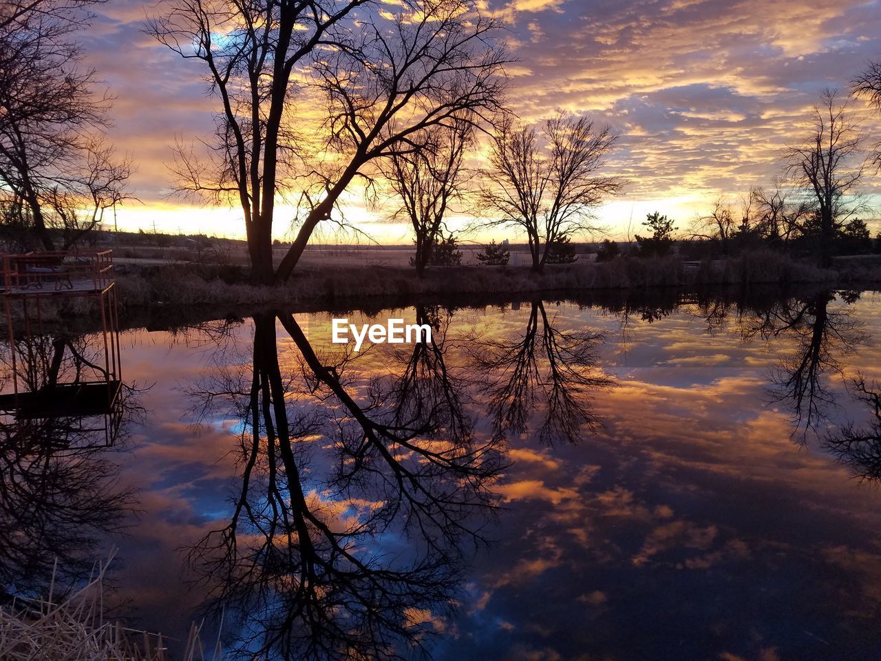 Scenic view of lake against sky during sunset