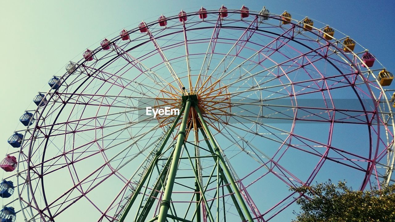 Low angle view of ferris wheel against sky